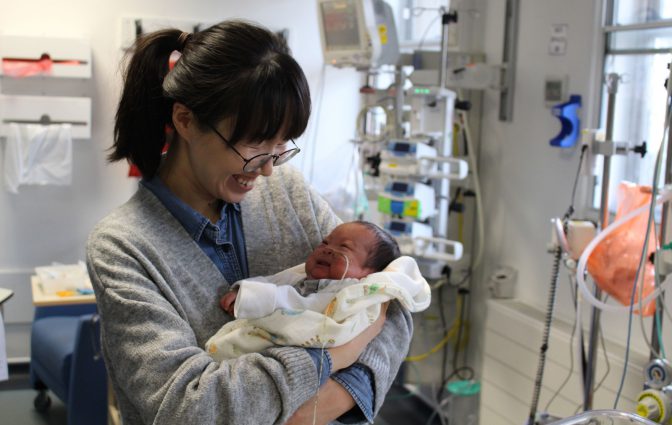Nurse holding a baby. Neonatal intensive care